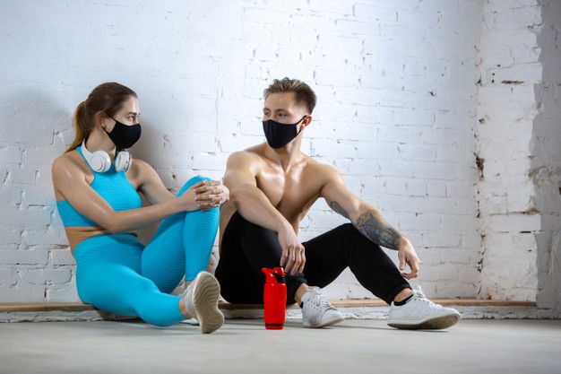 resting professional athletes training brick wall wearing face masks sport during quarantine coronavirus worldwide pandemic young couple practicing gym safe using equipment 155003 24687